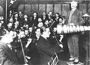 Sir Edward Elgar in a recording session cramming a reduced orchestra before the acoustical horn